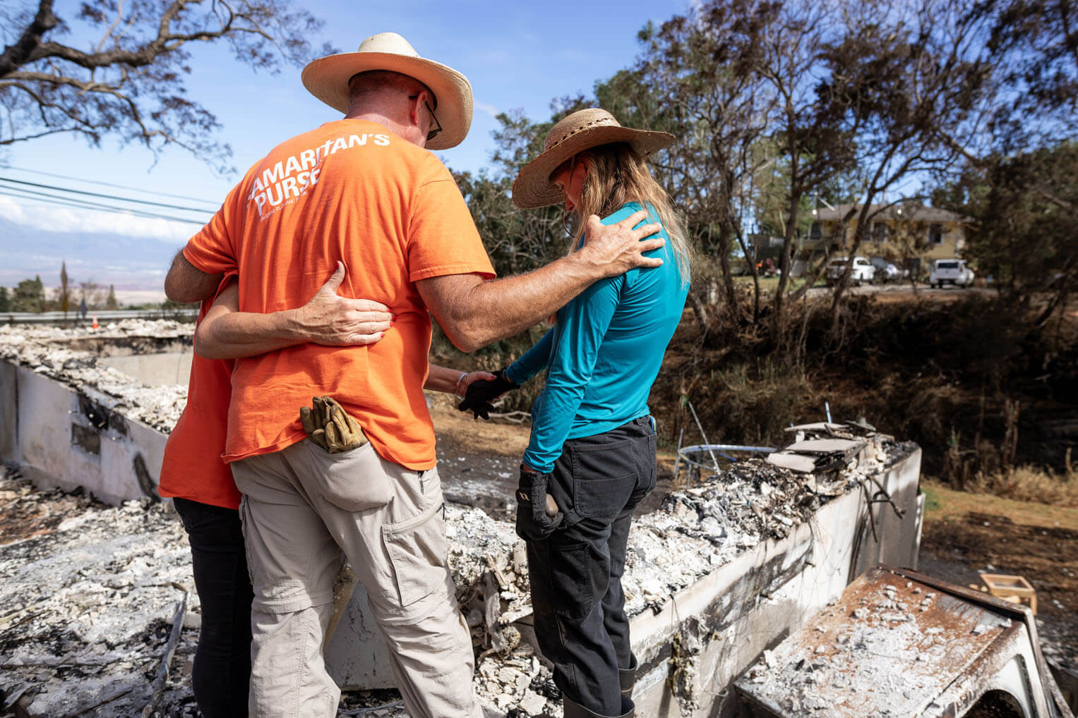 Volunteers prayed with a homeowner as they worked at her property.