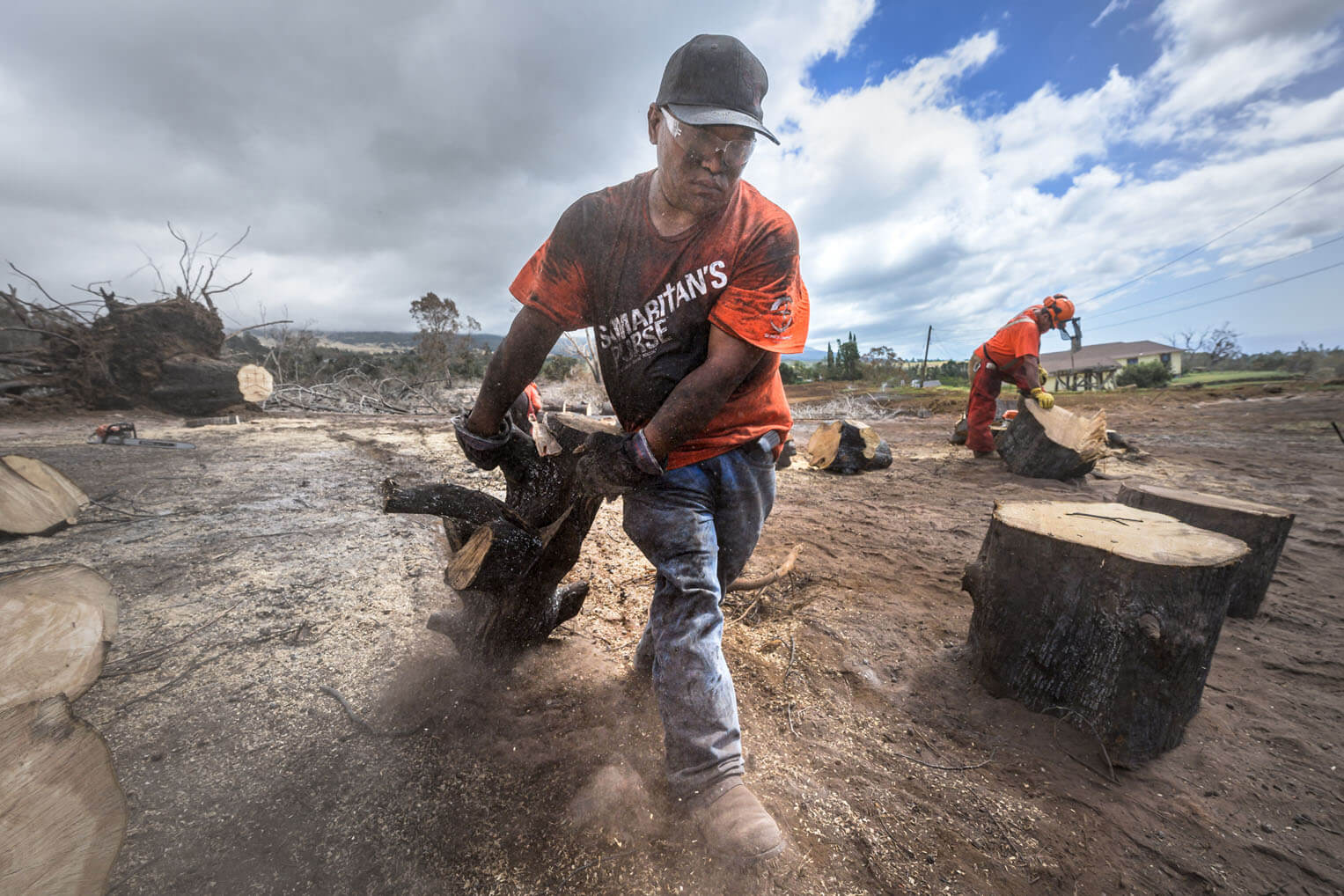 This local volunteer's soot-covered arms, shirt, and face are the tell-tale markings of work among the ashes of former homes and forests in this scorched paradise.